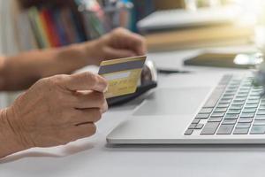 woman using laptop shopping purchasing online, paying by credit card, making payment, checking balance, browsing internet banking service. photo