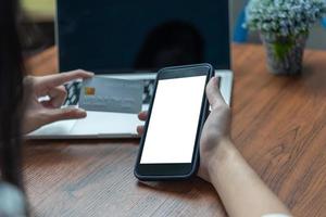 woman using smartphone mock up shopping purchasing online, paying by credit card, making payment, checking balance, browsing internet banking service. photo