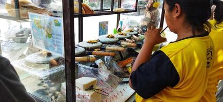 Surakarta, Indonesia, March 12, 2023. Making of kue leker,is a type of Indonesian crepe street food, made with flour, eggs, milk and sugar with various fillings such as banana, chocolate and cheese. photo