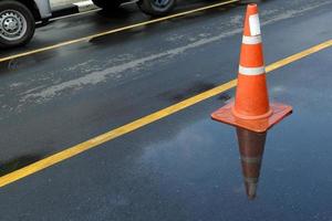 Traffic Cone and Reflection on the Road. photo