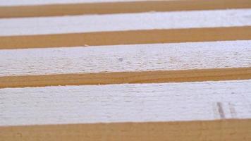 Sawn boards lie on the floor parallel to each other for drying. Preparation for the installation of an eco-friendly wooden floor in a rural house. Lumber from the sawmill video