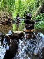 Balanced zen rock stacks in a creek. photo