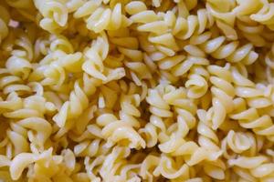 Fusilli spaghetti, Fusilli pasta as background image. Image texture spiral macaroni. Top view. Copy, empty space for text photo