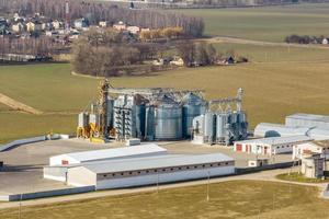 aerial view of agro-industrial complex with silos and grain drying line photo