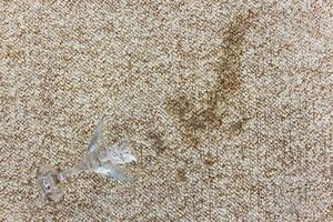 Glass of with alcoholic cocktail fell on carpet. photo
