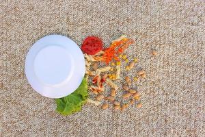 Plate of food fell on carpet. Top view. photo