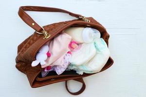 Mother's handbag with items to care for child. photo