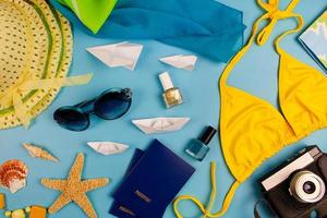 Summer accessories and items for travelon a blue background. Top view. photo