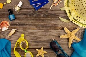 Summer accessories on wooden old background. Top view. photo