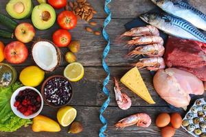 Healthy food of animal and vegetable origin on old wooden background. Concept of proper nutrition. Top view. Flat lay. photo