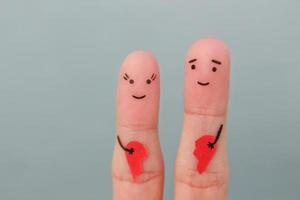 Fingers art of happy couple. Woman and man holding broken heart. Concept of joy after divorce. photo