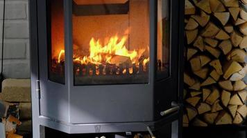 Firewood is burning in the furnace of the hearth close-up. Alternative eco-friendly heating, warm cozy room at home, burning wood video