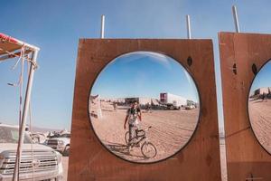 People walking towards sunset at a festival in the desert at the Burning Man Festival. photo