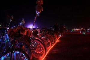 People walking towards sunset at a festival in the desert at the Burning Man Festival. photo