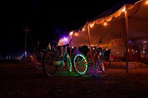 People walking towards sunset at a festival in the desert at the Burning Man Festival. photo