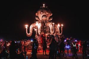 People walking towards sunset at a festival in the desert at the Burning Man Festival. photo