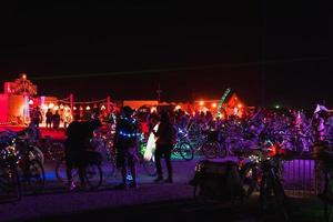 People walking towards sunset at a festival in the desert at the Burning Man Festival. photo