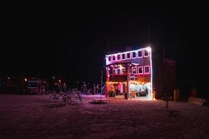 People walking towards sunset at a festival in the desert at the Burning Man Festival. photo