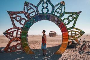 People walking towards sunset at a festival in the desert at the Burning Man Festival. photo