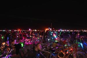 People walking towards sunset at a festival in the desert at the Burning Man Festival. photo