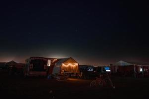 People walking towards sunset at a festival in the desert at the Burning Man Festival. photo