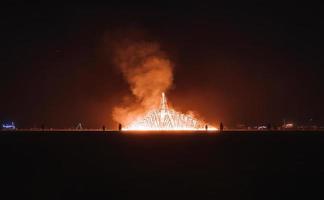 People walking towards sunset at a festival in the desert at the Burning Man Festival. photo