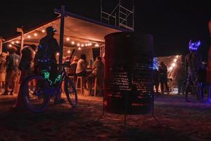 People walking towards sunset at a festival in the desert at the Burning Man Festival. photo