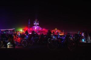 People walking towards sunset at a festival in the desert at the Burning Man Festival. photo