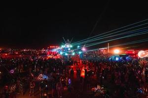 People walking towards sunset at a festival in the desert at the Burning Man Festival. photo