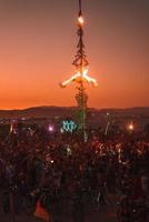 personas caminando hacia puesta de sol a un festival en el Desierto a el ardiente hombre festival. foto