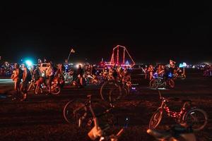 People walking towards sunset at a festival in the desert at the Burning Man Festival. photo