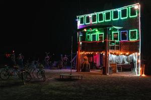 People walking towards sunset at a festival in the desert at the Burning Man Festival. photo