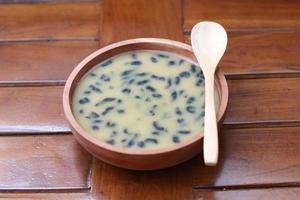 a close up of a bowl of traditional Indonesian drink called Dawet Ireng or black dawet. Indonesian traditional food photo concept.