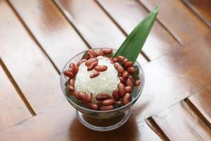 Es Kacang Merah or a cold drink made from red beans boiled with brown sugar served with coconut milk, shaved ice and covered with sweetened condensed milk chocolate and syrup. photo