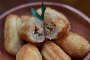 Comro or combro, a traditional Javanese snack made of deep fried grated cassava filled with a savory mix of oncom or fermented soy bean cake and chili photo