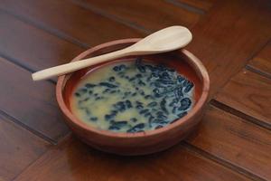 a close up of a bowl of traditional Indonesian drink called Dawet Ireng or black dawet. Indonesian traditional food photo concept.