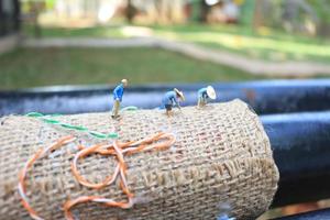 photo of a miniature figure with the concept of a farmer farming on a burlap sack