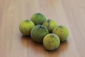 greenish yellow harp fruit isolated on money table has sweet and sour taste. Food concept photo. photo