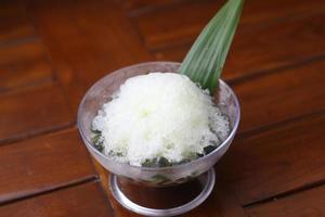 Es Kacang Merah or a cold drink made from red beans boiled with brown sugar served with coconut milk, shaved ice and covered with sweetened condensed milk chocolate and syrup. photo