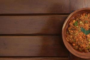 a close up Rujak Bebek or smashed fruit which is made from raw fruit crushed in a mortar and pestle and added with shrimp paste, chili and brown sugar. Indonesian traditional food photo concept.