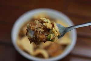 a close up of a ready-to-serve bowl of chicken porridge photo