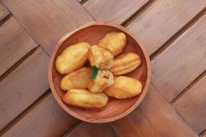 Comro or combro, a traditional Javanese snack made of deep fried grated cassava filled with a savory mix of oncom or fermented soy bean cake and chili photo