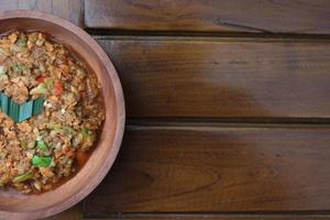 a close up Rujak Bebek or smashed fruit which is made from raw fruit crushed in a mortar and pestle and added with shrimp paste, chili and brown sugar. Indonesian traditional food photo concept.