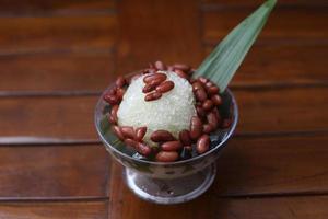 Es Kacang Merah or a cold drink made from red beans boiled with brown sugar served with coconut milk, shaved ice and covered with sweetened condensed milk chocolate and syrup. photo