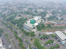 aerial view of the Darusalam mosque on the side of the highway. photo