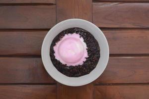 close up of a bowl of black sticky rice porridge photo