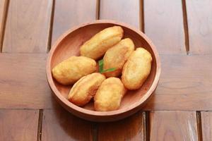 Comro or combro, a traditional Javanese snack made of deep fried grated cassava filled with a savory mix of oncom or fermented soy bean cake and chili photo