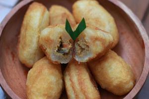 Comro or combro, a traditional Javanese snack made of deep fried grated cassava filled with a savory mix of oncom or fermented soy bean cake and chili photo
