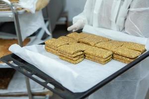 Assortment of cereal or protein bars that leave the assembly line at the factory. Healthy pre or post workout snacks with fruits, nuts and berries. photo