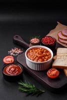 Delicious canned beans in a tomato in a white ceramic bowl photo